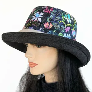 Sunblocker UV summer sun hat with wide brim, featuring pretty flowers on black, adjustable fit